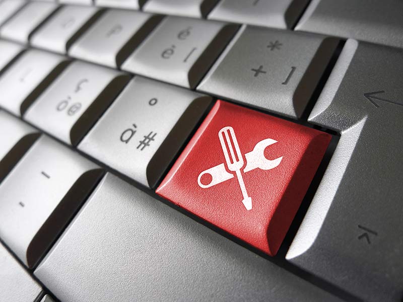 Keyboard with tools on key representing site maintenance